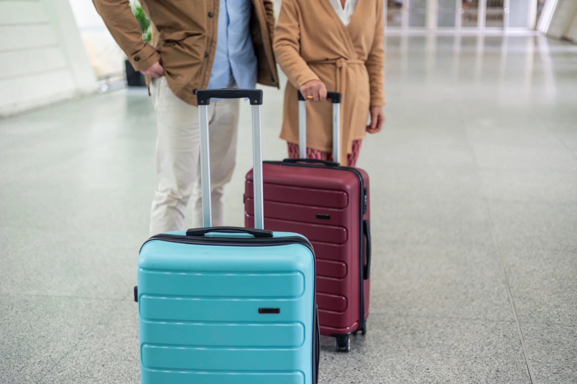 Travellers with luggage in an airport terminal